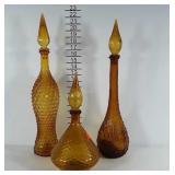 3 amber glass genie bottles. Heights are between