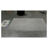 Two rugs. Small floral door mat and a grey area