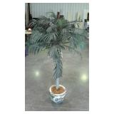 Faux palm tree in porcelain fishbowl planter.