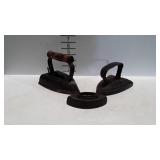 Three cast iron irons,  one with wooden handle,