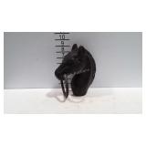 Cast iron horse head hitching post, shows rust.