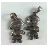 Two charms boy and girl, girl tests Sterling