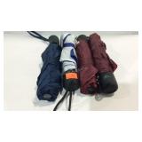 Four shedrain umbrellas