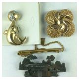 Three brooches and a clip