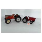 2 metal toy tractors. One looks to be a Farmall
