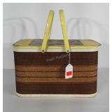 Picnic basket with metal handles and hinged lid.