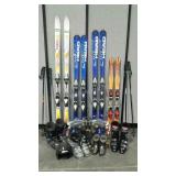Group of skis, ski poles and ski boots, plus one