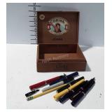 Cigar box with pens, many are fountain style
