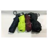 Four shedrain umbrellas