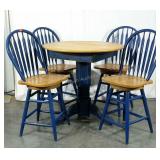 Pub table with four swivel arrow back stools.