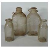 Four glass dairy bottles, two 7", two 10"