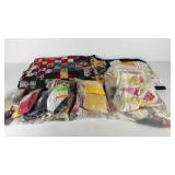 Two unfinished quilt tops and bags a cut fabric