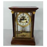 Wood and brass clock, with key. 11" H x 7" L x