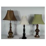 3 lamps. One looks to be a heavy brass lamp. The