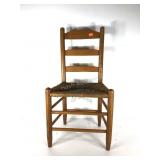 Rush seat ladderback chair, one break in rush as