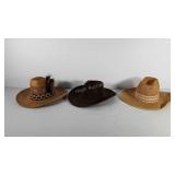 Three cowboy hats, two straw hats