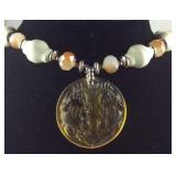 Glass beaded necklace with yellow pendant 24in