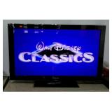 Samsung 55" flatscreen TV with stand and remote.