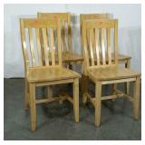 Four wood dining chairs, well worn, but sturdy.