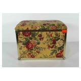 Upholstered trunk with gold tone metal trim and 2