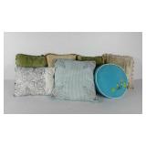 Throw pillows, four are velvety with ball fringe