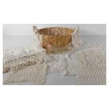 Doilies and glass donkey cart in basket