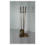 Brass toned stand with 2 fireplace tools: shovel