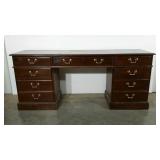 Double pedestal desk with center keyboard drawer.