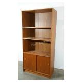 Large bookcase with sliding lower doors. Has