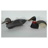 2 decoy ducks. One is wooden and one is plastic.