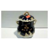 Decorative container with lid, gold accents, wave