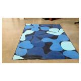 Blue flower-power area rug. 65" ×90". Leaves blue