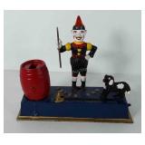 Trick dog cast iron coin bank, 8 1/2" L x 7" H
