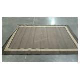 Area rug in grey and brown. Needs cleaning.