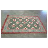 Woven rug with geometric native design. 48" ×
