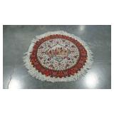 Small round wool rug with animals in medallion