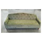 Green velour futon with tufting. Needs some