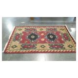 Woven rug with geometric native design. 48"×72".