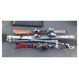 Three sets of skis and a few poles