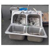 Two double Bay stainless steel sinks with faucets