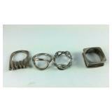 Four rings three are Sterling 15.8g sizes 7, 6,