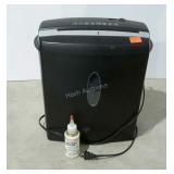 Omnitech shredder with bottle of lubricant.