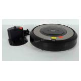 Roomba Robot Vacuum with charger. Powers on.