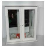 Cabinet with glass doors and mirrored back. Has