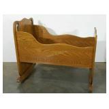Large baby cradle with laminate oak finish.