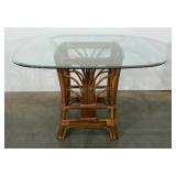 Rattan table with beveled glass top. Shows wear.