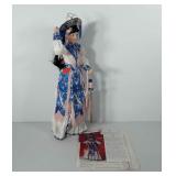 Porcelain doll with stand and paperwork, Mu-lan