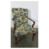 Older upholstered chair with claw and ball feet,