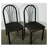 Two metal chairs, seat pads show wear