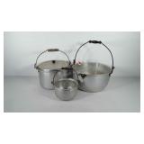 Three aluminum pots, one includes lid, includes